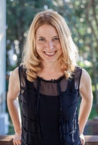 Headshot of Laura Vanderkam, smiling at the camera with a black shirt